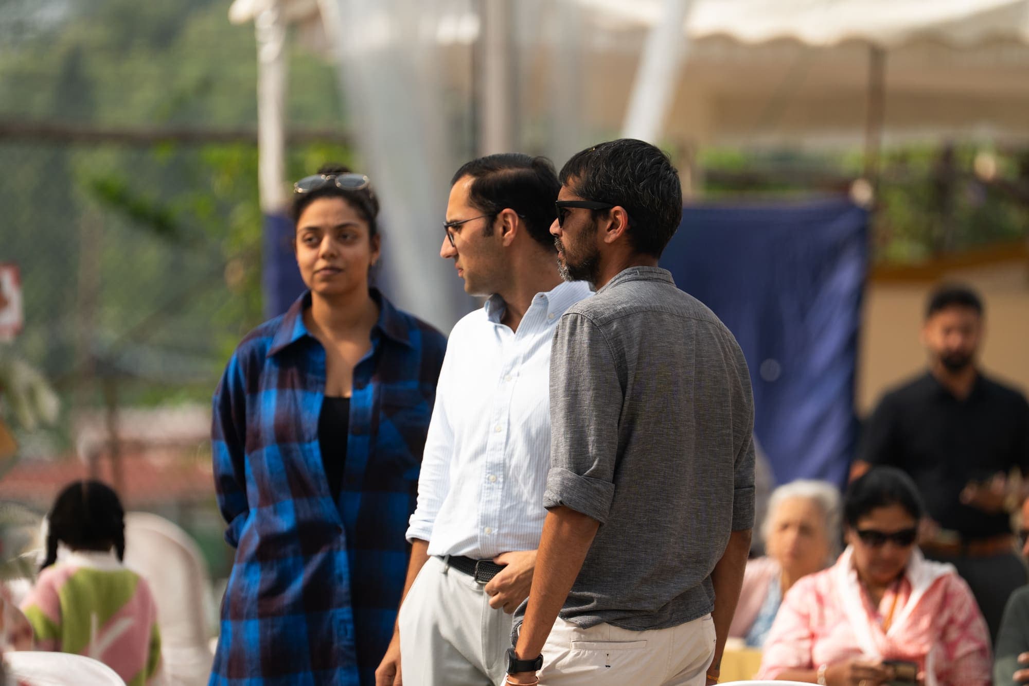 Guests arriving through the fete grounds in afternoon light