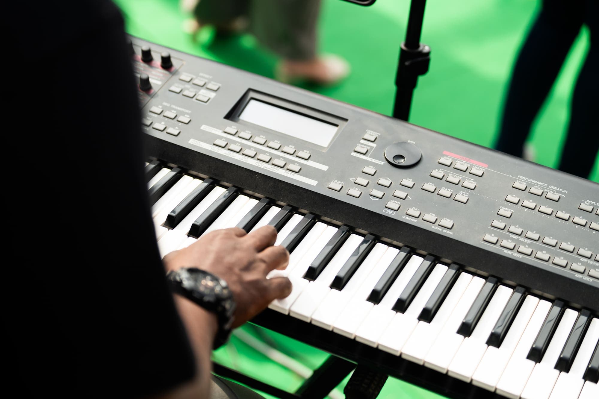 A musician's hands on the keyboard during soundcheck