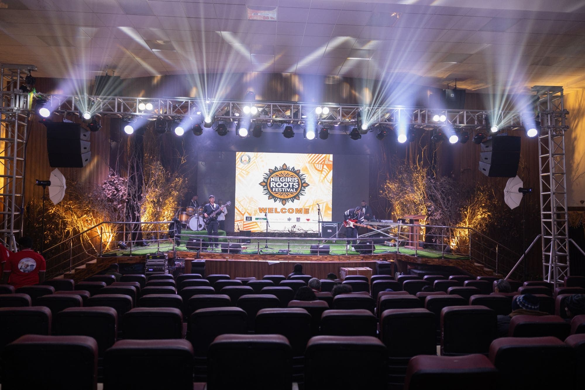 The festival stage and auditorium, the band playing under the lighting truss