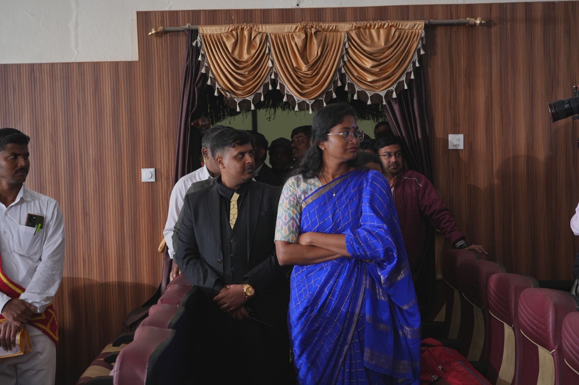 Guests gathered at the back of the auditorium between sessions